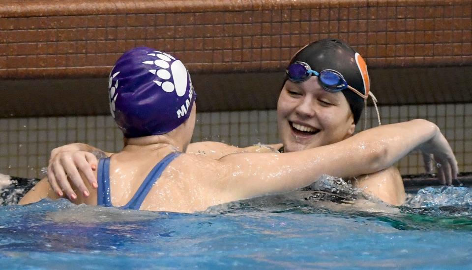 Jackson’s Abra Manofsky and Green’s Olivia Scheibelhoffer celebrate after the girls 50-yard freestyle in the Division I district meet at Cleveland State, Saturday, Feb. 17, 2024.