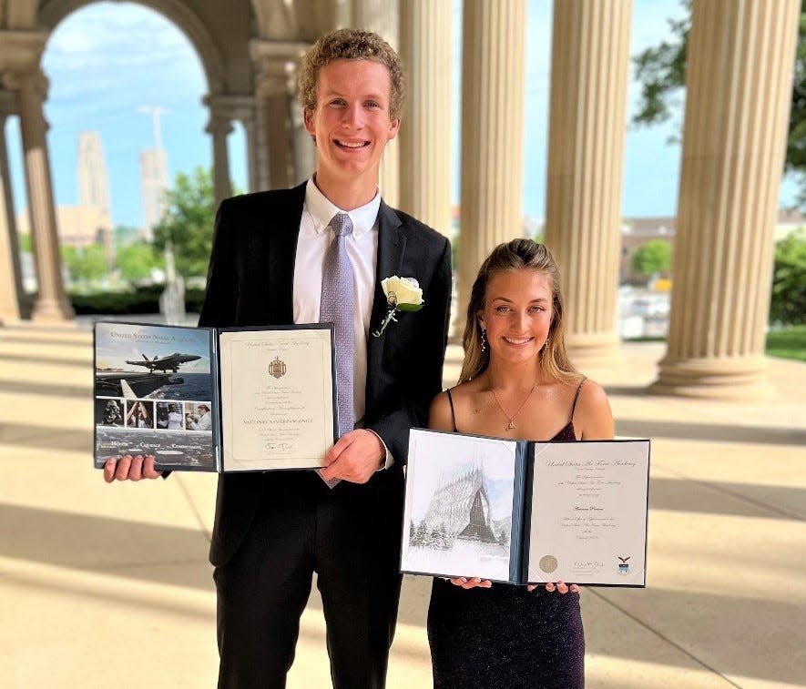 Lakeview High prom dates Nathan Pawlowicz and Ari Pontoni pose for photos outside the Federal Center in downtown Battle Creek. The two are also showing off their acceptance letters to attend the Naval Academy and Air Force Academy, respectively.