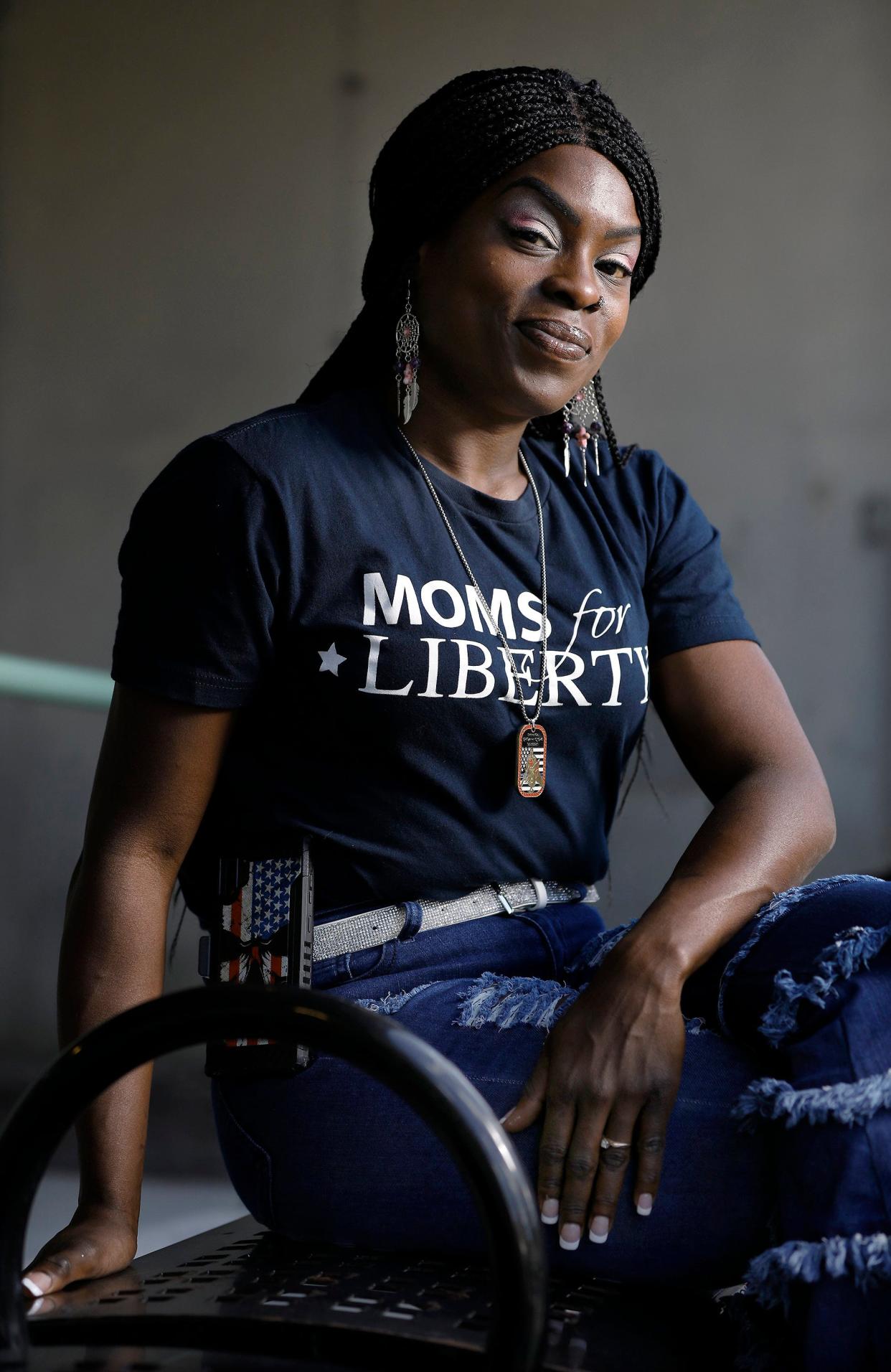 Tia Bess, the new national outeach director of Moms For Liberty, rests at a bus stop on North Newman Street in downtown Jacksonville where she spent a lot of time in the late 1990's, when she was homeless and living at the Sulzbacher Center.