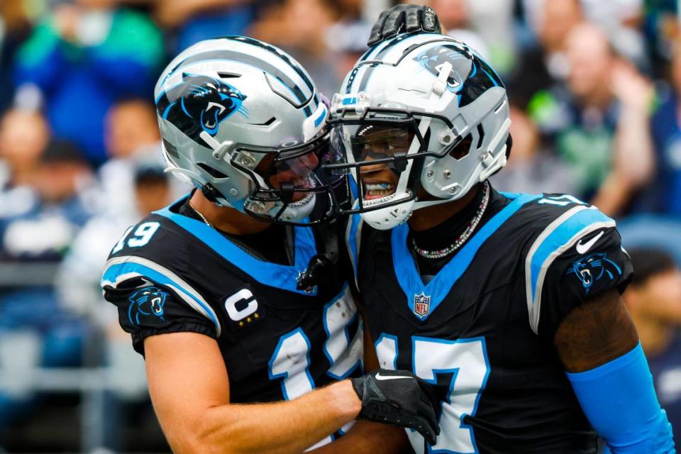 Carolina Panthers wide receiver DJ Chark Jr. (17) celebrates with wide receiver Adam Thielen (19) after catching a touchdown pass against the Seattle Seahawks during the second quarter at Lumen Field.