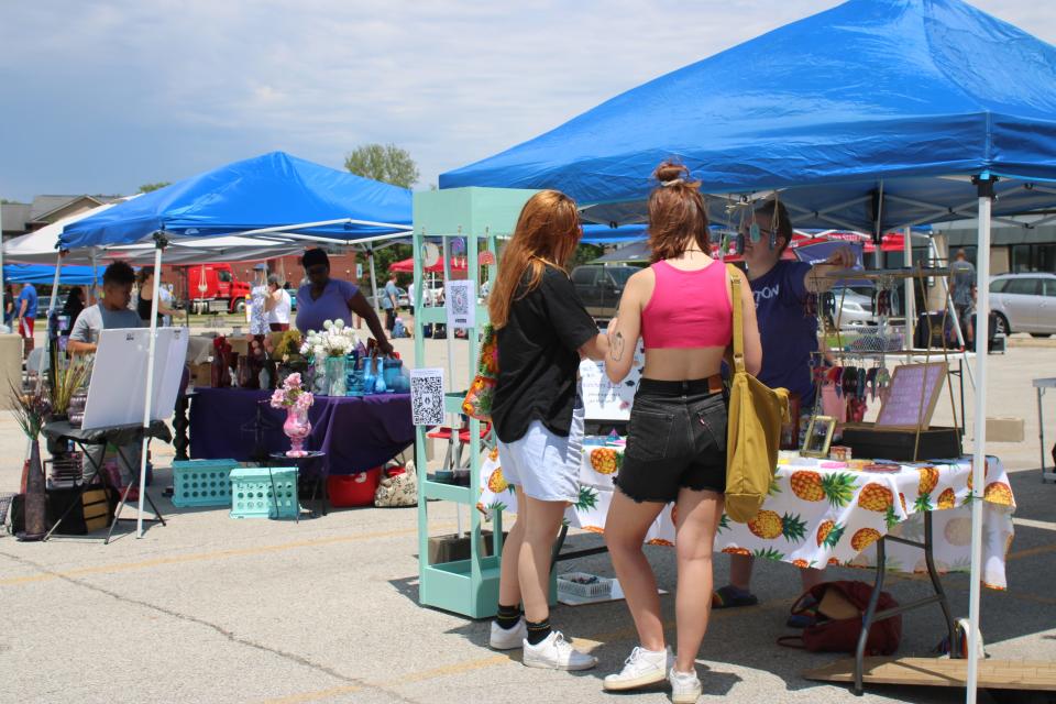 People at South District's Diversity Market, located in the Pepperwood Plaza parking lot in Iowa City, May 28.