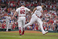 St. Louis Cardinals' Albert Pujols, right, is congratulated by first base coach Stubby Clapp (82) after hitting a two-run home run off Chicago Cubs relief pitcher Brandon Hughes, left, during the eighth inning of a baseball game Sunday, Sept. 4, 2022, in St. Louis. (AP Photo/Jeff Roberson)