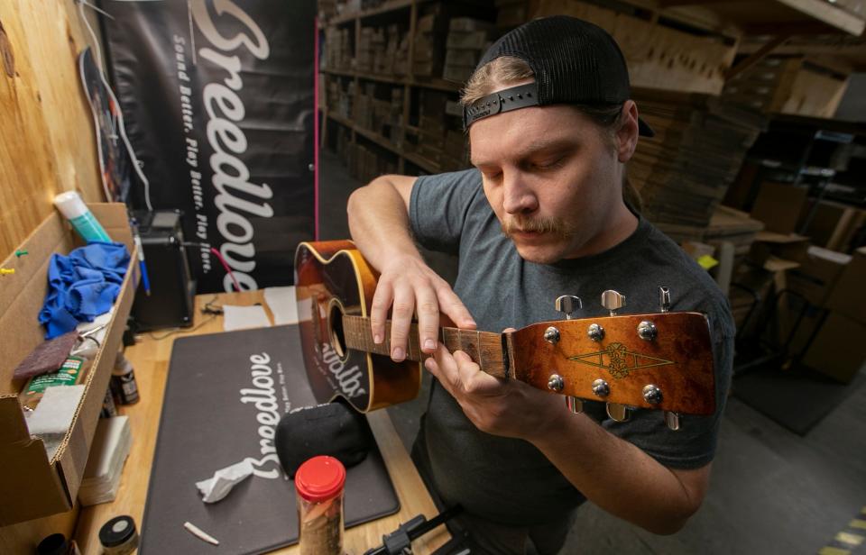 Guitar technician George Mosher works on a guitar for a customer at Total Music Source in Cape Coral.