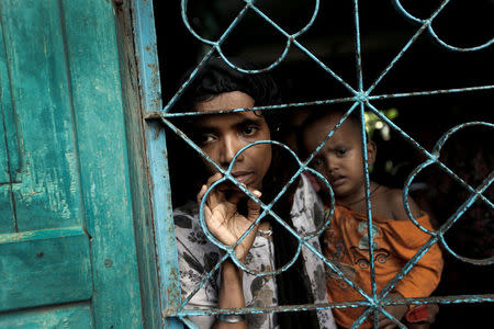 A newly arrived Rohingya refugee waits to be transferred to a camp in Cox's Bazar, Bangladesh, October 2, 2017. REUTERS/Cathal McNaughton TPX IMAGES OF THE DAY