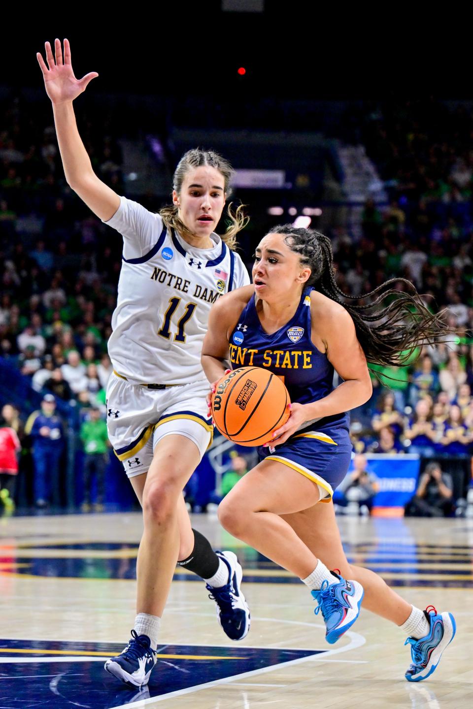 Kent State's Dionna Gray (21) drives to the basket as Notre Dame's Sonia Citron (11) defends in the first half of an NCAA Tournament first-round game Saturday in South Bend, Ind.