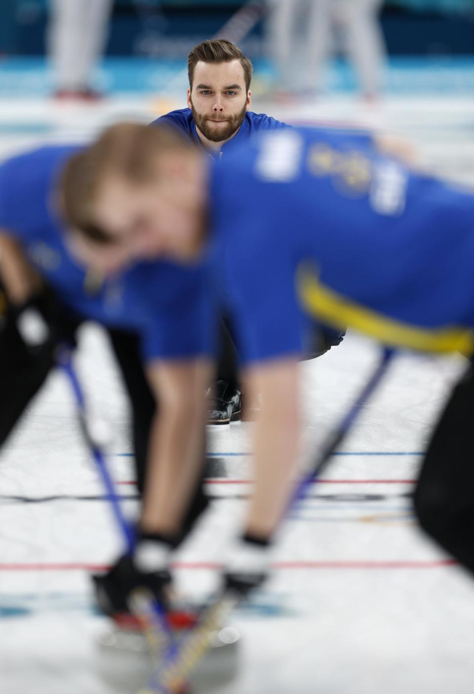 <p>Vice-skip Oskar Eriksson of Sweden watches the shot. REUTERS/John Sibley </p>