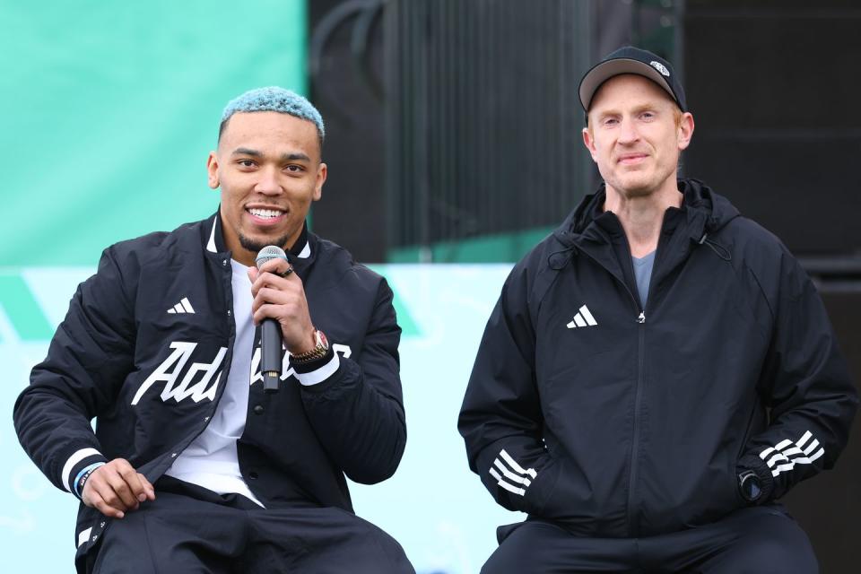 las vegas, nevada february 09 l r amon ra st brown and fabien steinberg speak in a huddle on the field as adidas debuts its brand campaign with a star studded roster of athletes at resorts world las vegas on february 09, 2024 in las vegas, nevada photo by joe scarnicigetty images for adidas