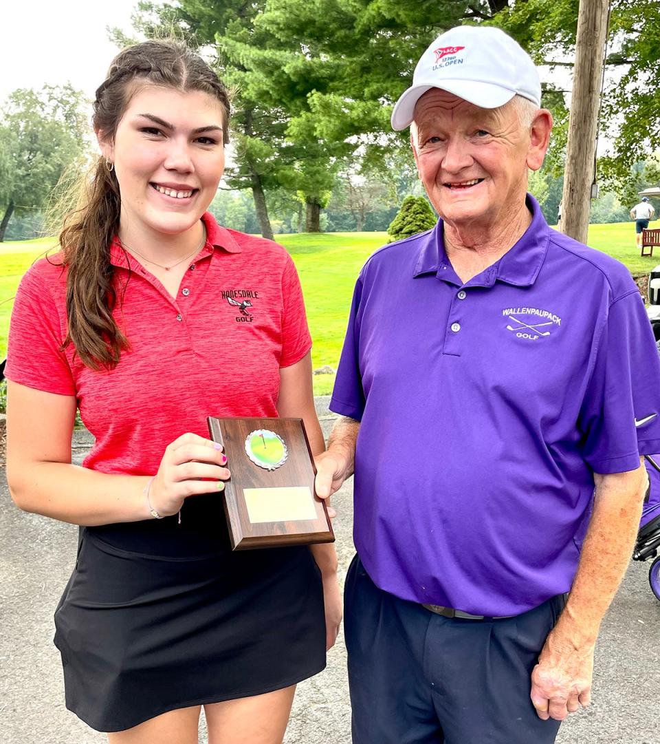 Lady Hornet senior golfer Kayla Benson finished as runner-up at the 2023 Bob Simons Cup, shooting an 83 over 18 holes at Honesdale Golf Club. Benson is pictured here accepting her plaque from Coach Simons.