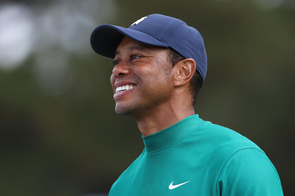 Tiger Woods smiles during a golf round.