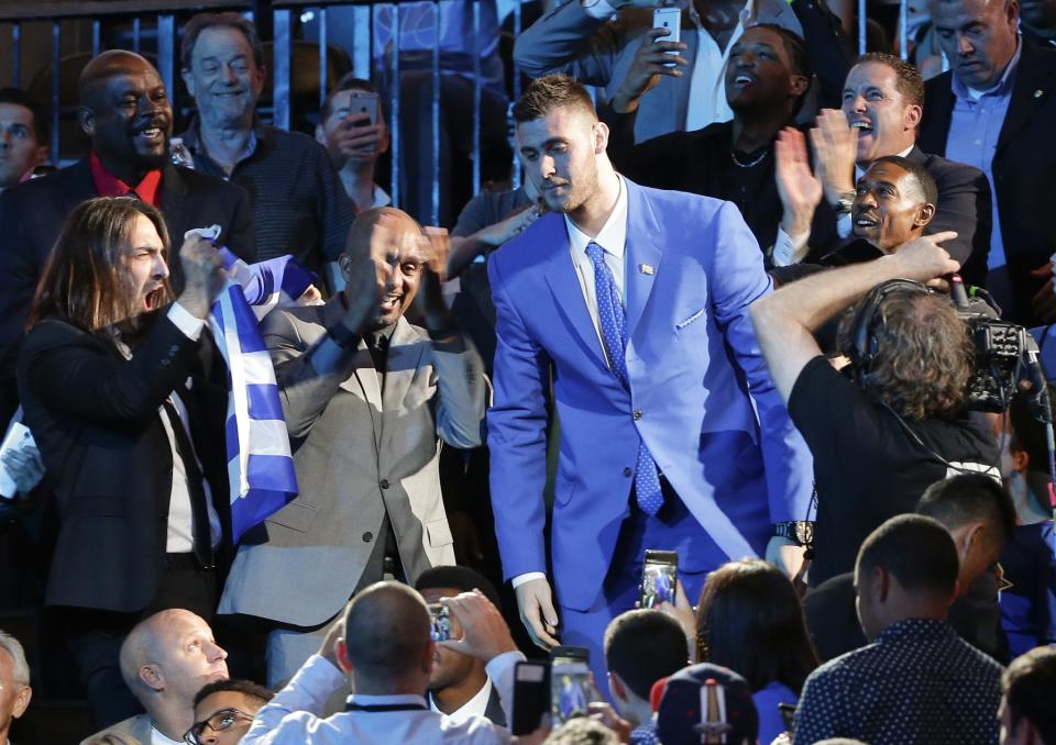 <p>Georgios Papagiannis, center, stands as he is announced as the 13th overall pick by the Phoenix Suns during the NBA basketball draft, Thursday, June 23, 2016, in New York. (AP Photo/Frank Franklin II) </p>