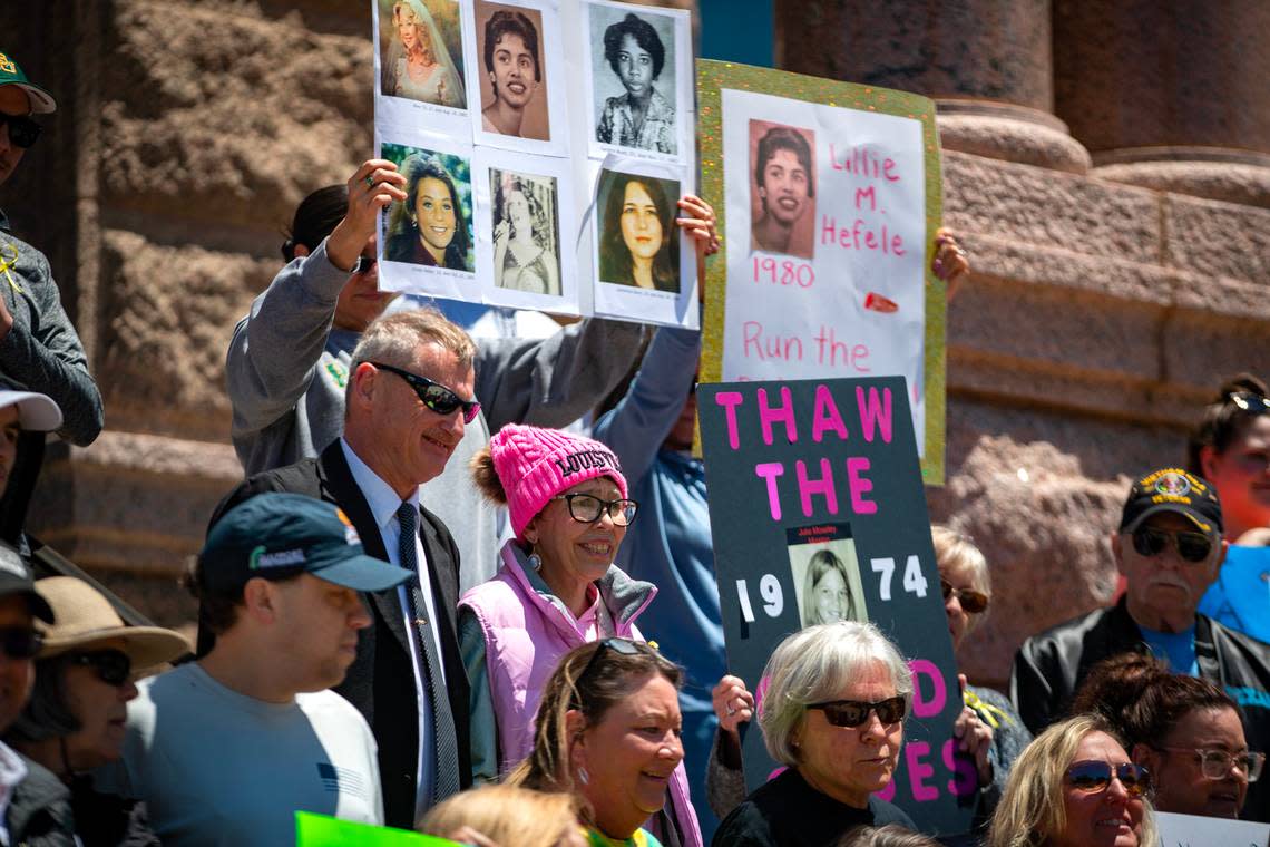 Melissa Highsmith (wearing a pink hat) and her husband, John Brown, gather along with about 100 people at a rally to solve cold cases in downtown Fort Worth on Saturday, April 29, 2023. Highsmith, abducted in 1971, was reunited with her family in 2022.