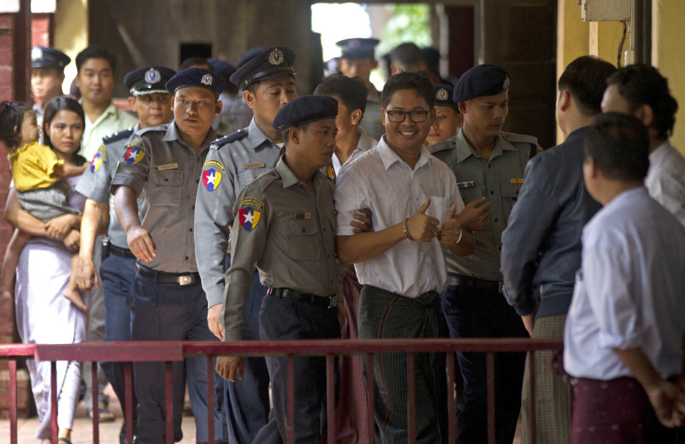 Reuters journalist Wa Lone, center, is escorted by polices upon arrival at the court Monday, Sept. 3, 2018, in Yangon, Myanmar. A Myanmar court sentenced two Reuters journalists, Wa Lone and Kyaw Soe Oo, to seven years in prison Monday for illegal possession of official documents, a ruling that comes as international criticism mounts over the military's alleged human rights abuses against Rohingya Muslims. (AP Photo/Thein Zaw)