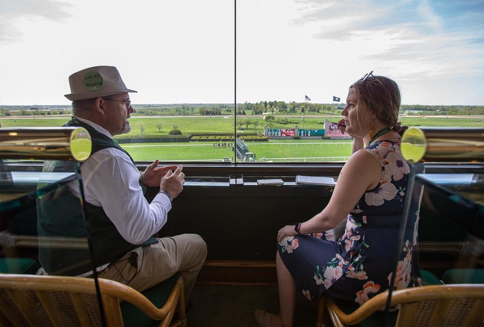 Greg Burke, left, talks everything horses with Courier Journal columnist Maggie Menderski in a corporate box suite at Keenland on Thursday afternoon. Burke is one of several 'Betologists' on staff that help racegoers get the most of their experience by offering betting advice, directions around the track and a familiar, welcoming smile. April 21, 2023