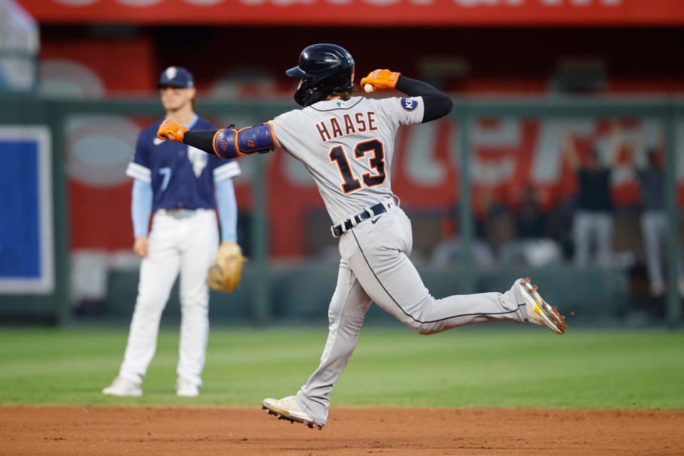 Tigers catcher Eric Haase gestures while running the bases, past Royals shortstop Bobby Witt Jr., after hitting a home run during the second inning on Friday, Sept. 9, 2022, in Kansas City, Missouri.