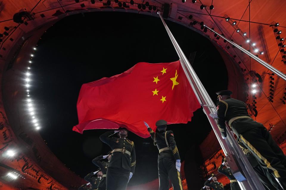 The Chinese national flag is raised during the opening ceremony of the 2022 Winter Olympics, Friday, Feb. 4, 2022, in Beijing. (AP Photo/Natacha Pisarenko)