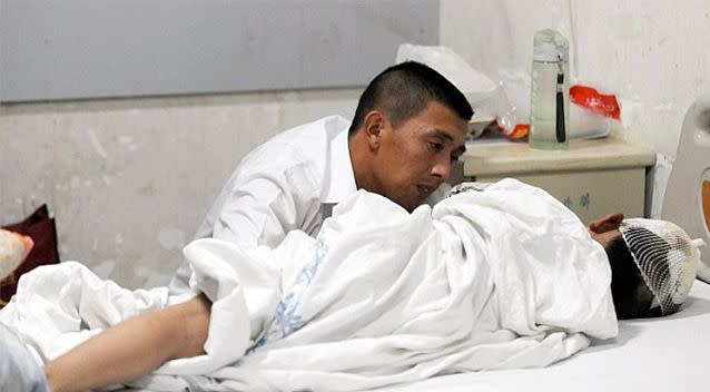 A father consoles his son after the attack at the primary school. Photo: AFP/Getty.