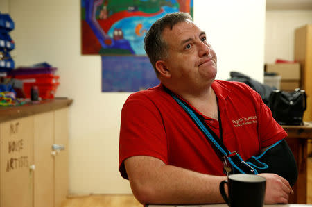 Community volunteer Brendon O'Donnell speaks with a journalist at a community centre on the Matson housing estate, in Gloucester. REUTERS/Peter Nicholls