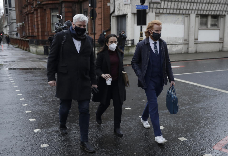 Wikileaks spokesman Kristinn Hrafnsson, left, with Stella Moris girlfriend of Julian Assange, center, and Joseph A Farrell of Wikileaks walk towards Westminster Magistrates Court for his Bail hearing in London, Wednesday, Jan. 6, 2021. On Monday Judge Vanessa Baraitser ruled that Julian Assange cannot be extradited to the US. because of concerns about his mental health. Assange had been charged under the US's 1917 Espionage Act for "unlawfully obtaining and disclosing classified documents related to the national defence". Assange remains in custody, the US. has 14 days to appeal against the ruling. (AP Photo/Matt Dunham)