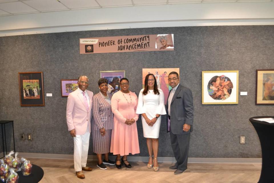 Honorees Dr. Keisha Callins and Dr. Patrice Walker stand with board members of RHMMWC in front of the exhibit wall on display at the Douglass Theatre in honor of Ruth Hartley Mosley while attending the inaugural Central Georgia Women of Impact Awards on Saturday.