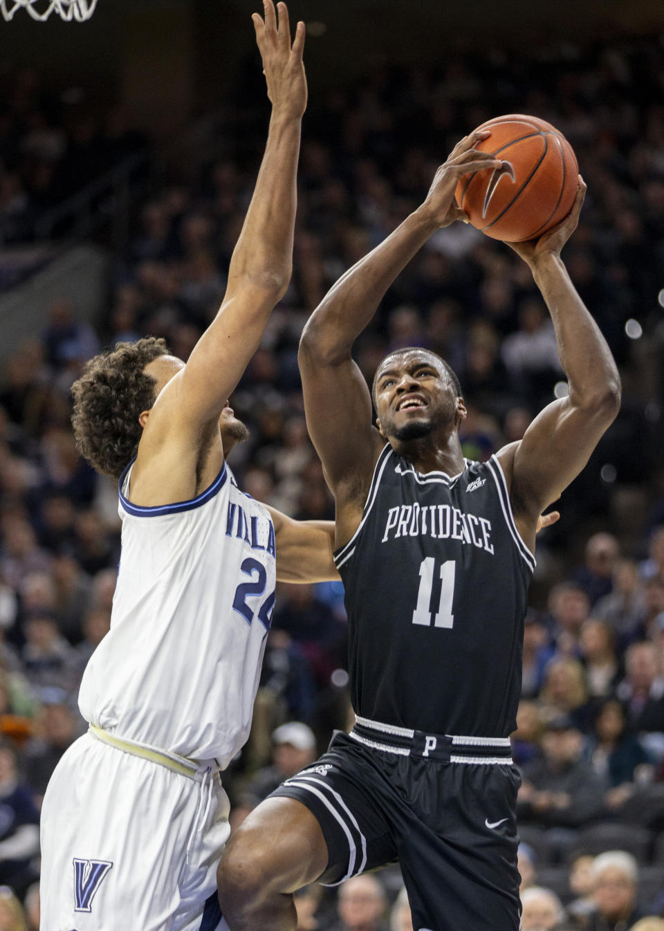 Providence guard Alpha Diallo (11) takes a shot over Villanova forward Jeremiah Robinson-Earl (24) during the second half of an NCAA college basketball game, Saturday, Feb. 29, 2020, in Philadelphia, Pa. Providence won 58-54. (AP Photo/Laurence Kesterson)