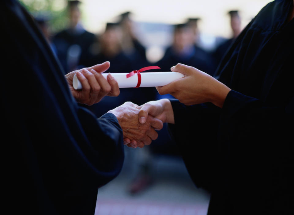 A graduates receives their diploma