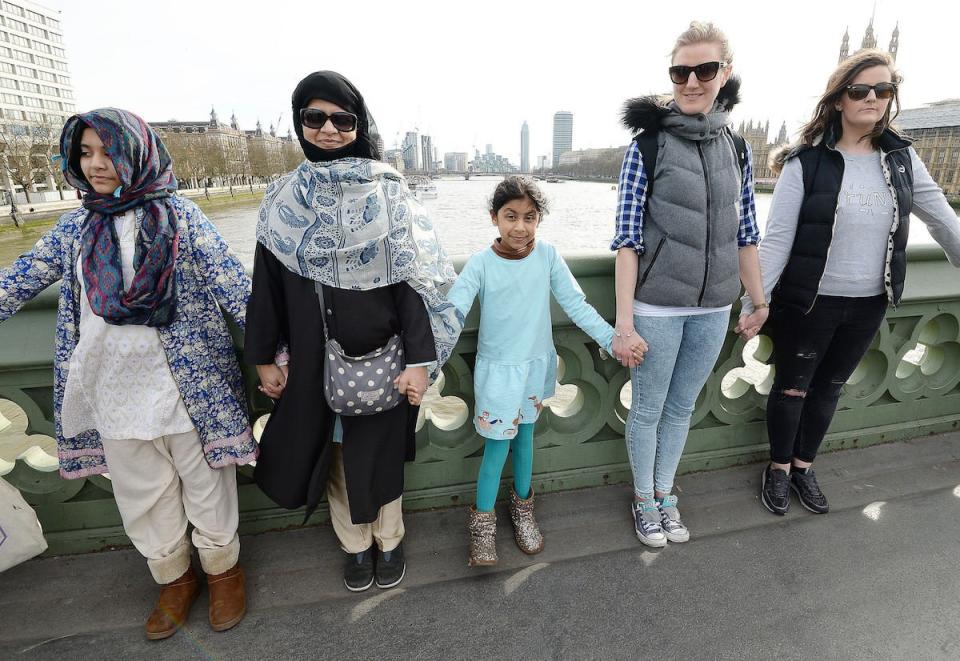 A group of women, some with their daughters, link hands on Westminster bridge in central London in an act of solidarity organised by Women's March London to pay tribute to the victims of the Westminster terrorist attack.