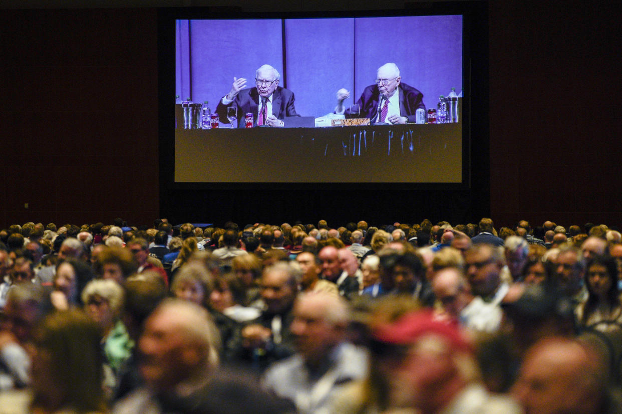 Shareholders in overflow rooms watch on big screens as Berkshire Hathaway Chairman and CEO Warren Buffett, left, and Vice Chairman Charlie Munger preside over the annual Berkshire Hathaway shareholders meeting in Omaha, Neb., Saturday, May 4, 2019. An estimated 40,000 people are thought to be in town for the event, where Buffett and Munger spend hours answering questions. (AP Photo/Nati Harnik)