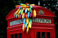 An installation of paper bananas attached to a public telephone box, created by Brazilian graphic artist Breno Pineschi as part of as part of the arts campaign 'Rio Occupation London', is seen in South Kensington, London July 19, 2012. Before London hands over the Olympic baton to Rio De Janeiro, 30 of Rio's top artists have 30 days to blast the capital with their city's most vibrant, cutting edge, culture. REUTERS/Andre Camara (BRITAIN - Tags: ENTERTAINMENT SOCIETY SPORT OLYMPICS)