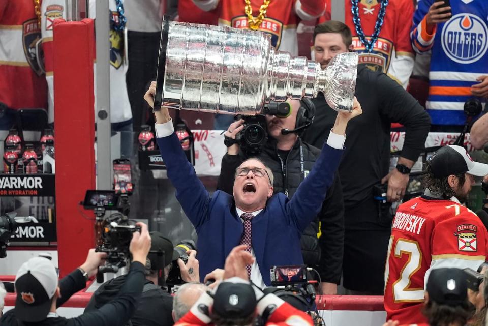 Florida Panthers head coach Paul Maurice raises the Stanley Cup trophy after Game 7 of the NHL Stanley Cup Final against the Edmonton Oilers on Monday, June 24, 2024, in Sunrise, Fla. The Panthers defeated the Oilers 2-1. (AP Photo/Rebecca Blackwell)