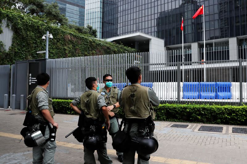 Riot police officers stand guard outside Central Government Complex as a second reading of a controversial national anthem law takes place in Hong Kong