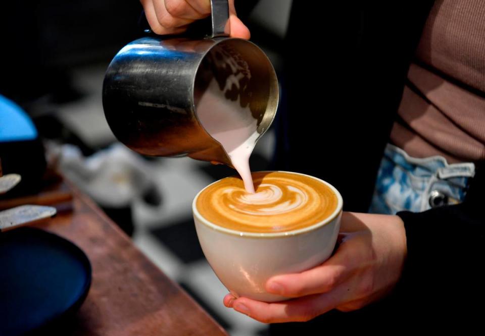 Christine Hughes makes a latte at Elixr on Beaver Avenue in State College on Monday.