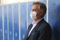 Miroslav Skoro, leader of the Homeland Movement wears a face mask at a polling station in Zagreb, Croatia, Sunday, July 5, 2020. Amid a spike of new coronavirus cases, voters in Croatia cast ballots on Sunday in what is expected be a close parliamentary race that could push the latest European Union member state further to the right. (AP Photo/Daniel Kasap)