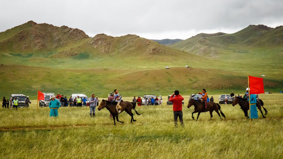 Jockeys cross the finish line during a Naadam festival in Uliastai, in Western Mongolia. - Tessa Chan/South China Morning Post/Getty Images
