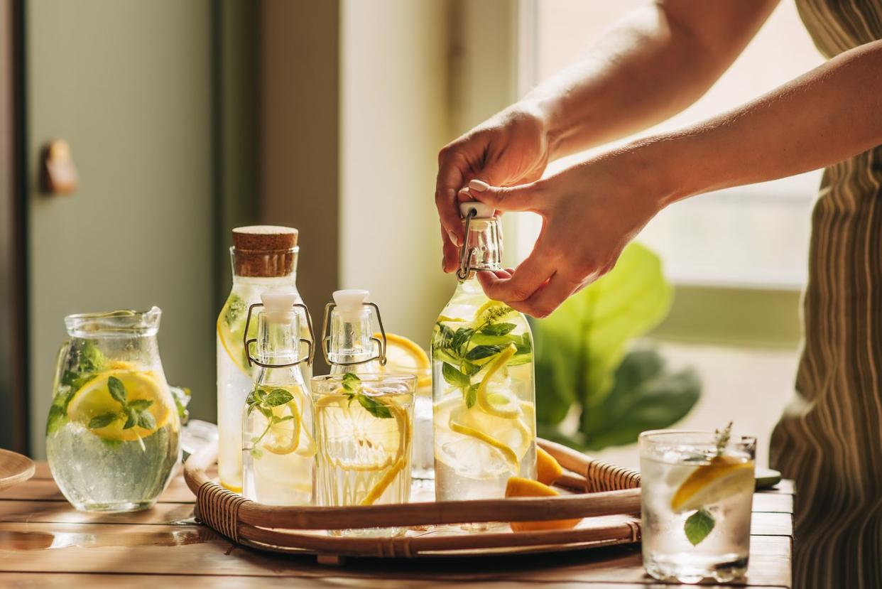 unrecognizable person pouring lemonade from jug into the glass