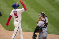 Philadelphia Phillies' Mickey Moniak, left, reacts to his three-run home run as San Francisco Giants catcher Buster Posey, right, looks on during the second inning of a baseball game, Wednesday, April 21, 2021, in Philadelphia. (AP Photo/Chris Szagola)