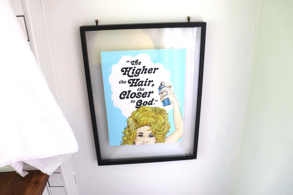 A Dolly Parton sign reading "The higher the hair, the closer to God."