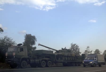 A truck transporting a Russian military tank is seen on a roadside near the border with Ukraine in the Rostov region, August 7, 2014. REUTERS/Maria Tsvetkova