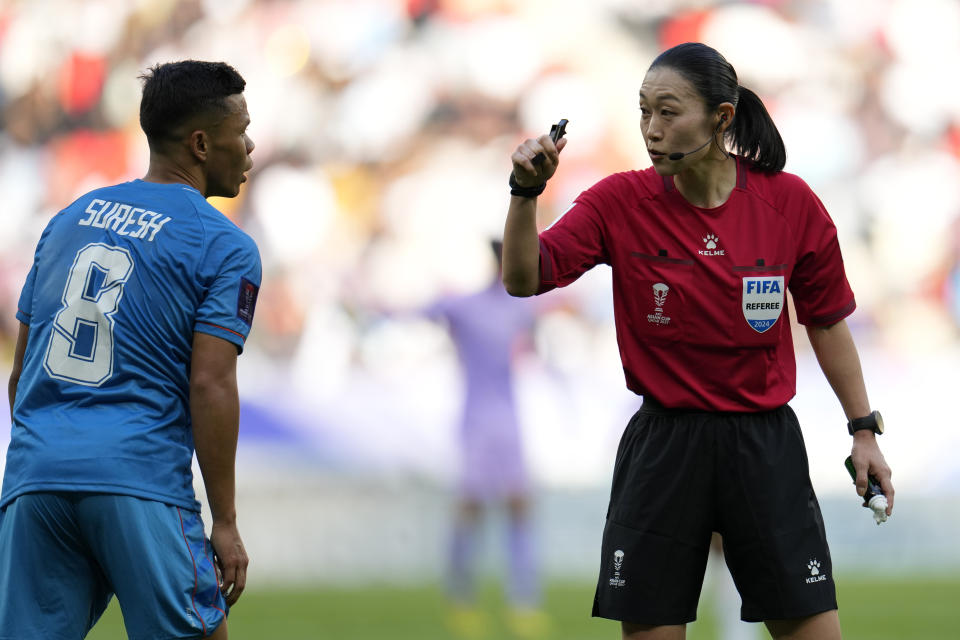 Referee Yamashita Yoshimi of Japan, right, speaks with India's Suresh Singh Wangjam during the Asian Cup Group B soccer match between Australia and India at Ahmad Bin Ali Stadium in Doha, Qatar, Saturday, Jan. 13, 2024. (AP Photo/Aijaz Rahi)