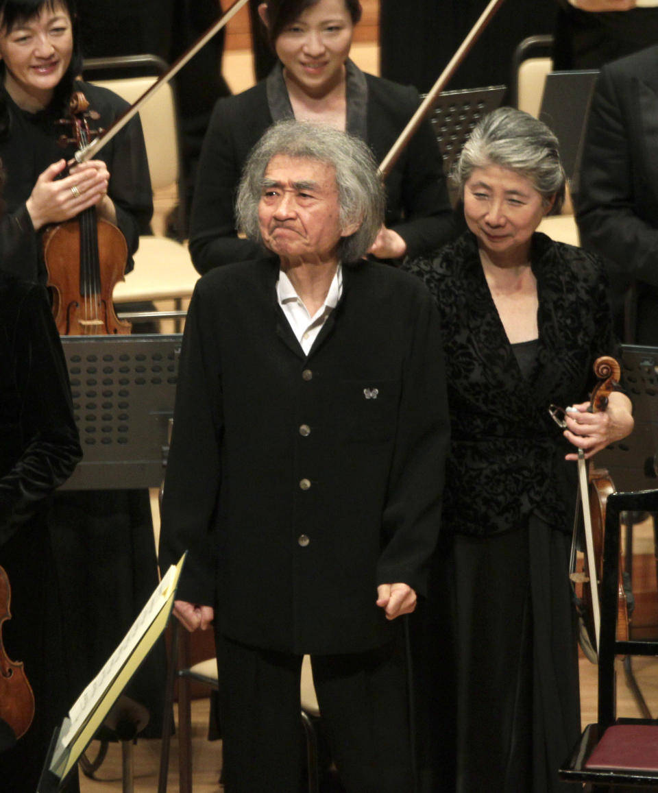 FILE - Seiji Ozawa, center, reacts as he greets the audience after a performance with violoncellist Dai Miyata, unseen, and the Mito Chamber Orchestra at Suntory Hall in Tokyo, Sunday, Jan. 22, 2012. World-renowned conductor Ozawa has died of heart failure at his home in Tokyo, his management office said Friday, Feb. 9, 2024. He was 88.(AP Photo/Shizuo Kambayashi, File)