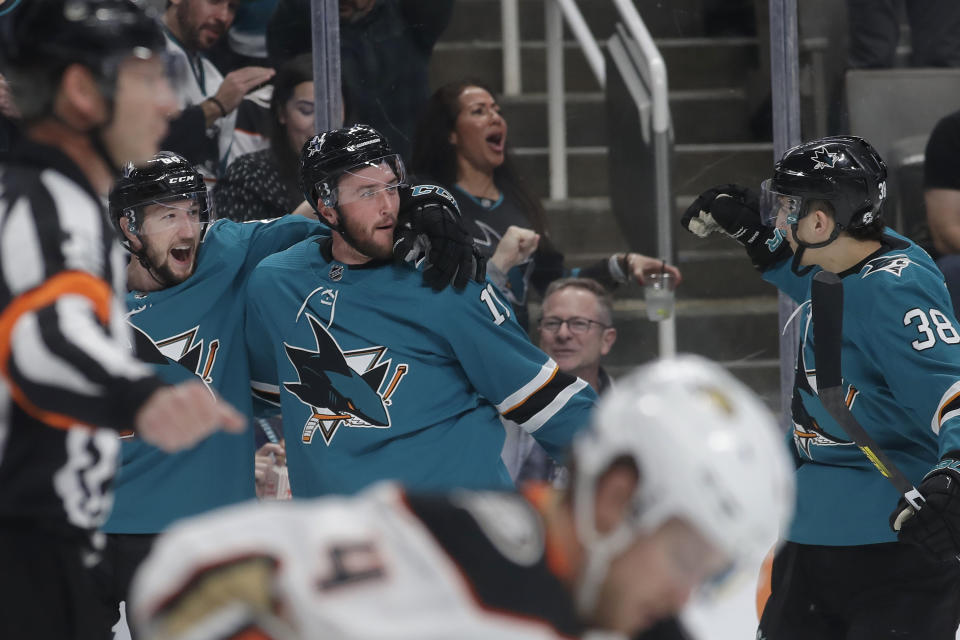 San Jose Sharks right wing Stefan Noesen, middle, is congratulated by center Melker Karlsson, left, and defenseman Mario Ferraro (38) after scoring a goal against the Anaheim Ducks during the first period of an NHL hockey game in San Jose, Calif., Monday, Jan. 27, 2020. (AP Photo/Jeff Chiu)