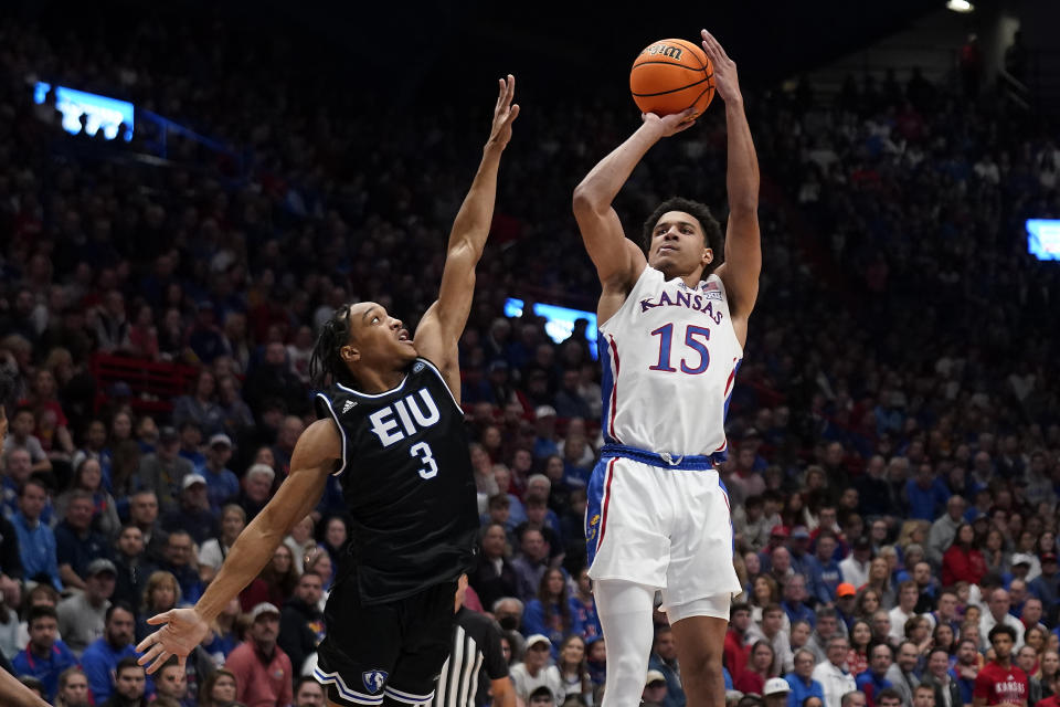 Kansas guard Kevin McCullar Jr. shoots over Eastern Illinois guard Nakyel Shelton (3) during the first half of an NCAA college basketball game Tuesday, Nov. 28, 2023, in Lawrence, Kan. (AP Photo/Charlie Riedel)