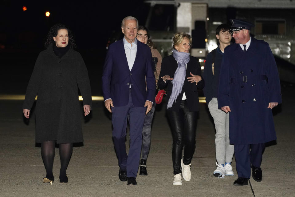 President Joe Biden and first lady Jill Biden arrive to board Air Force One at Andrews Air Force Base, Md., on Tuesday, Dec. 27, 2022, with their grandchildren Natalie and Robert and escorted by Air Force Col. William Chris McDonald, right, and his wife Diana McDonald, left. Biden and his family are traveling to St. Croix, U.S. Virgin Islands. (AP Photo/Manuel Balce Ceneta)