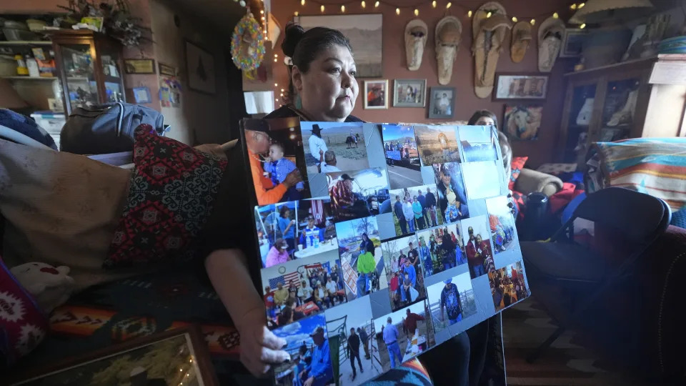 Shoshone-Paiute tribal member Tanya Smith Beaudoin holds photos of her father, who died from cancer, at her home in Owyhee, Nev., on the Duck Valley Indian Reservation on March 14, 2024. (AP Photo/Rick Bowmer)