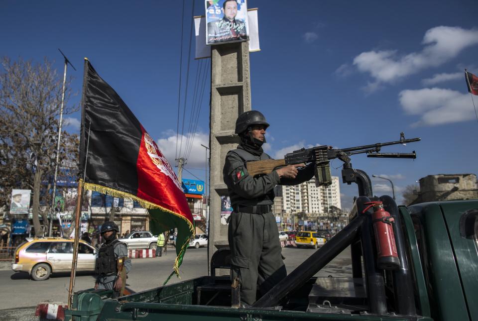 Afghan policemen takes up a position outside the Interior Ministry, after a suicide bomb blast in Kabul April 2, 2014. (REUTERS/Zohra Bensemra)