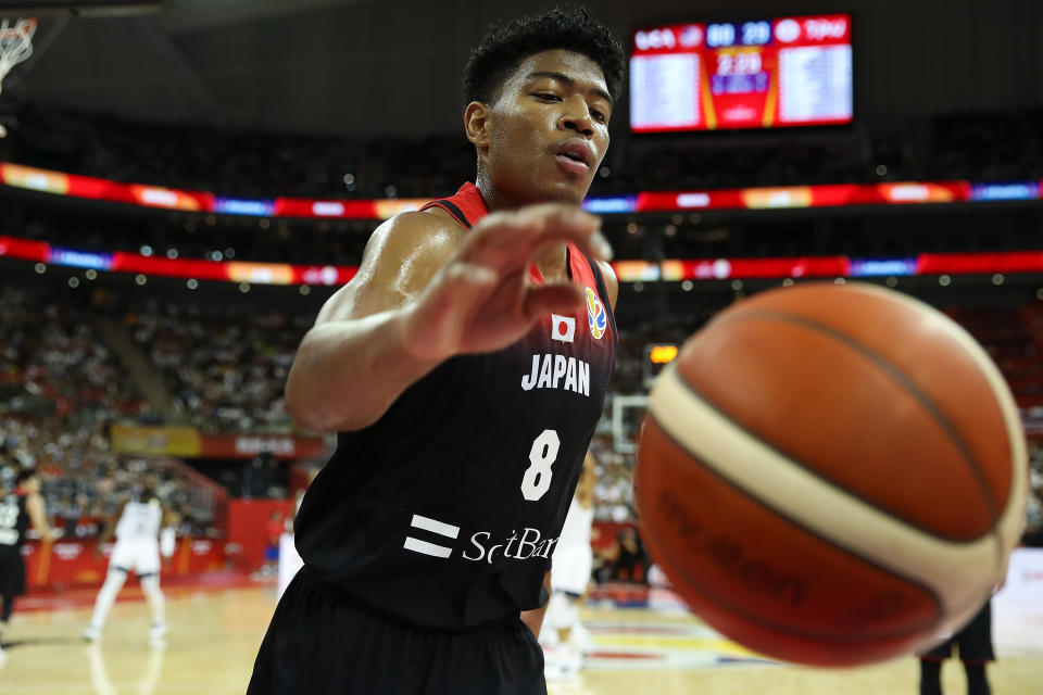 Rui Hachimura reaches for basketball while wearing a Japan uniform