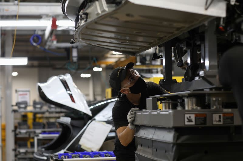 FILE PHOTO: Workers assemble electric vehicles at the Lucid Motors plant in Casa Grande