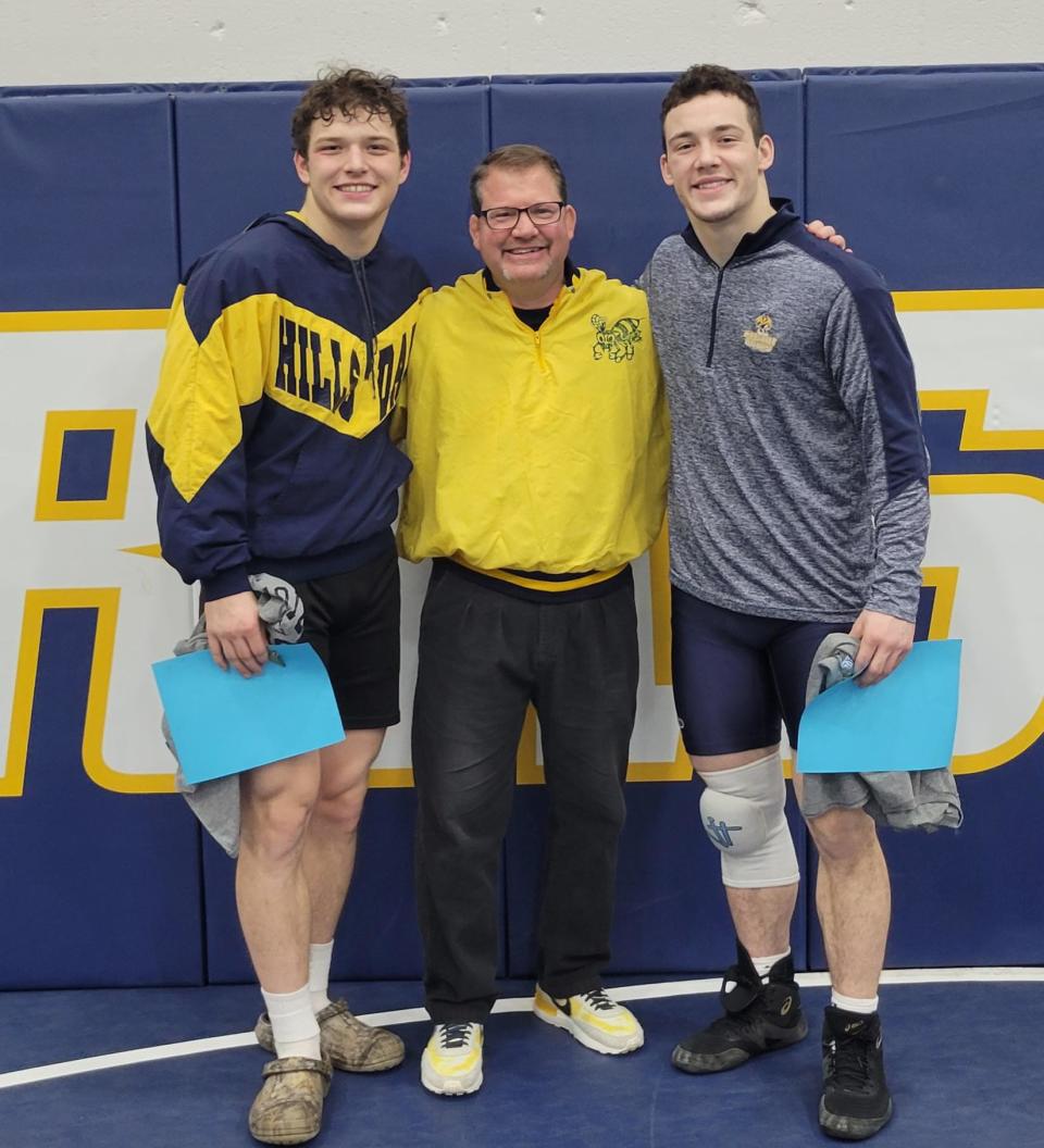 John Petersen (left) and Stephen Petersen (right) celebrate their wins with coach David Beck.