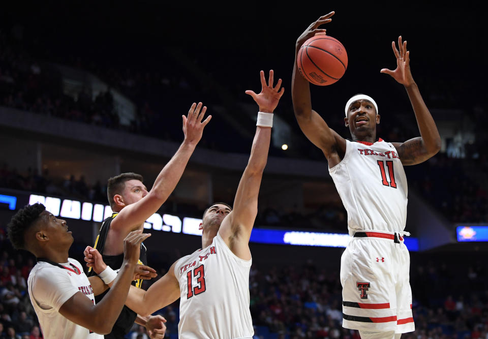 <p>Tariq Owens #11 of the Texas Tech Red Raiders gets the rebound near teammate Matt Mooney #13 during the first half of the first round game of the 2019 NCAA Men’s Basketball Tournament against the Northern Kentucky Norse at BOK Center on March 22, 2019 in Tulsa, Oklahoma. (Photo by Harry How/Getty Images) </p>