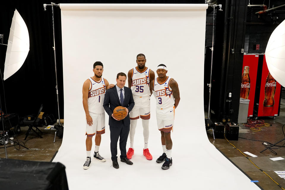 Phoenix Suns' Devin Booker (1), Kevin Durant (35), Bradley Beal (3) and owner Mat Isbia pose for a portrait during the NBA basketball team's media day, Monday, Oct. 2, 2023, in Phoenix. (AP Photo/Matt York)