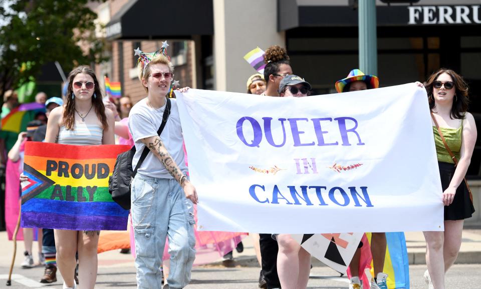 Queer in Canton, led by founder Abby Henry, far right, participates in the festival Saturday.